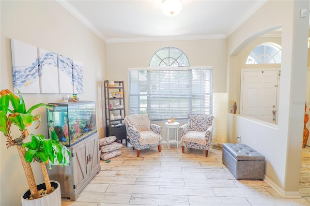 living area with light hardwood / wood-style floors and crown molding