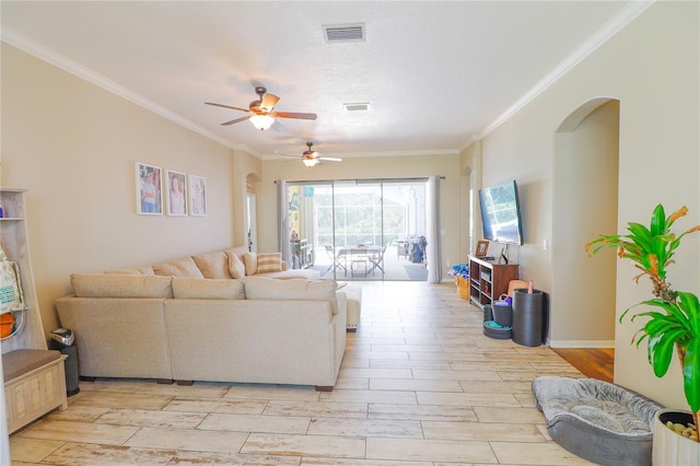 living room with a textured ceiling, ceiling fan, and ornamental molding