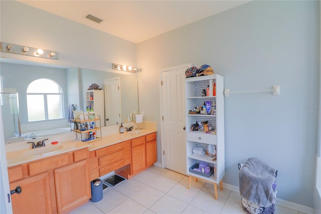 bathroom featuring vanity, tile patterned floors, and a bathing tub