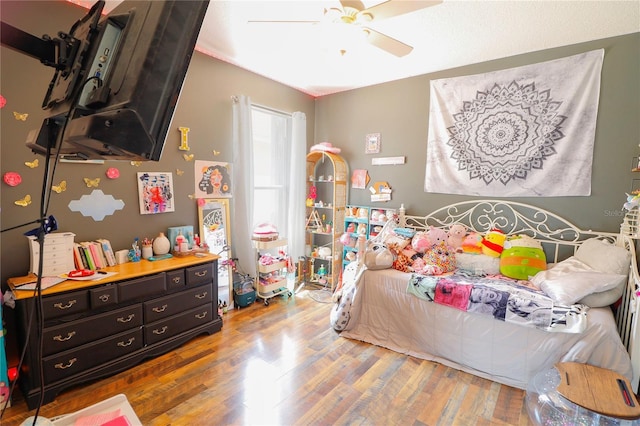 bedroom featuring hardwood / wood-style floors and ceiling fan