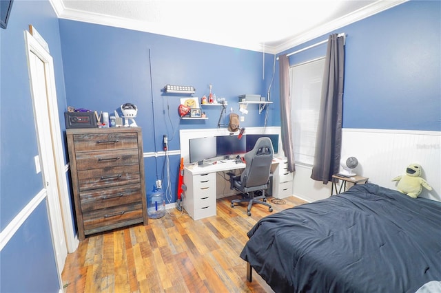 bedroom featuring hardwood / wood-style flooring and crown molding