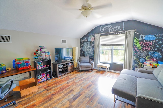 living room with ceiling fan, wood-type flooring, and lofted ceiling