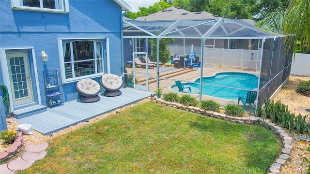 view of swimming pool with a yard, a patio area, and a lanai