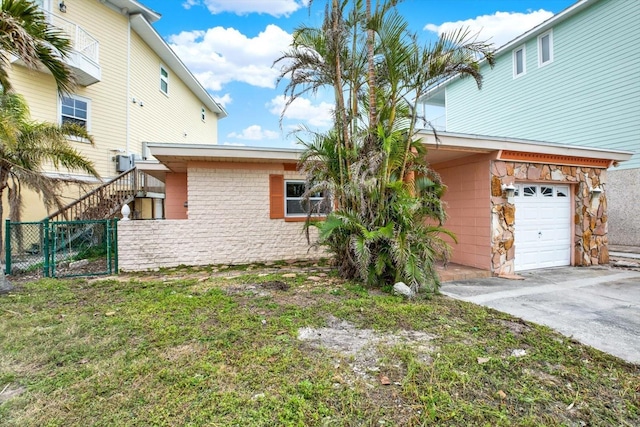 exterior space featuring a garage and a front lawn