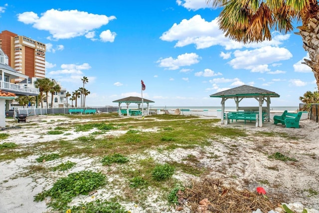 view of community featuring a view of the beach, a gazebo, and a water view