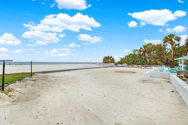 view of yard with a view of the beach and a water view