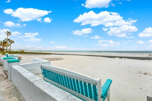 view of property's community with a beach view and a water view