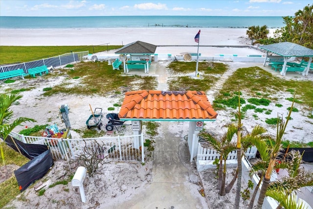 bird's eye view featuring a water view and a beach view