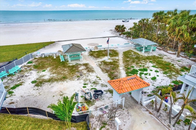 bird's eye view with a water view and a beach view