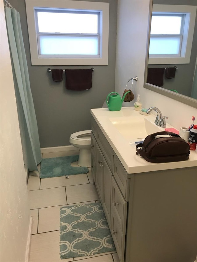 bathroom with vanity, tile patterned flooring, and toilet