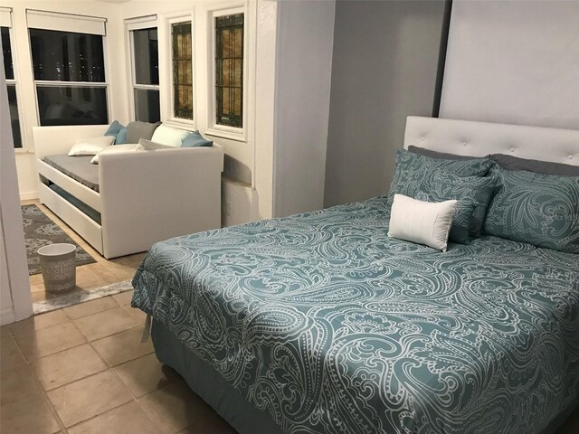 bedroom with light tile patterned floors