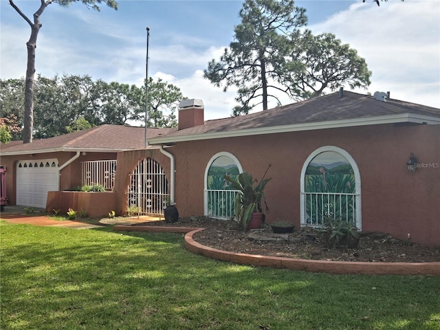 ranch-style house featuring a front lawn and a garage