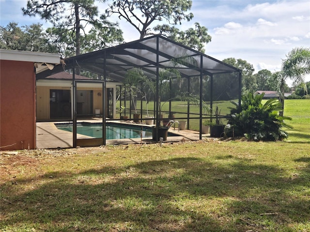 view of pool featuring a patio, glass enclosure, and a lawn