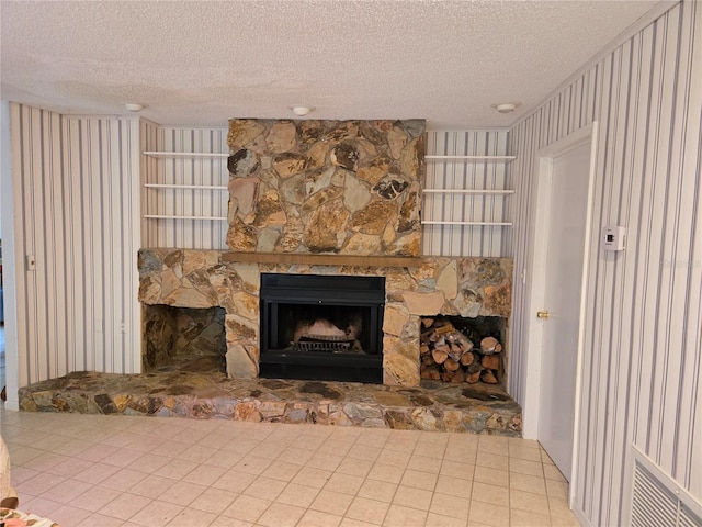 interior details with a textured ceiling and a fireplace