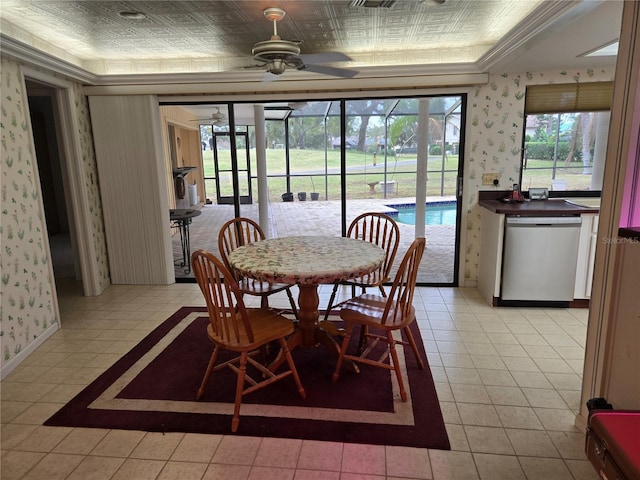 dining space with ceiling fan, crown molding, light tile patterned flooring, and a raised ceiling