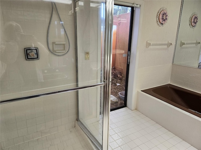 bathroom with a shower with shower door and tile patterned floors