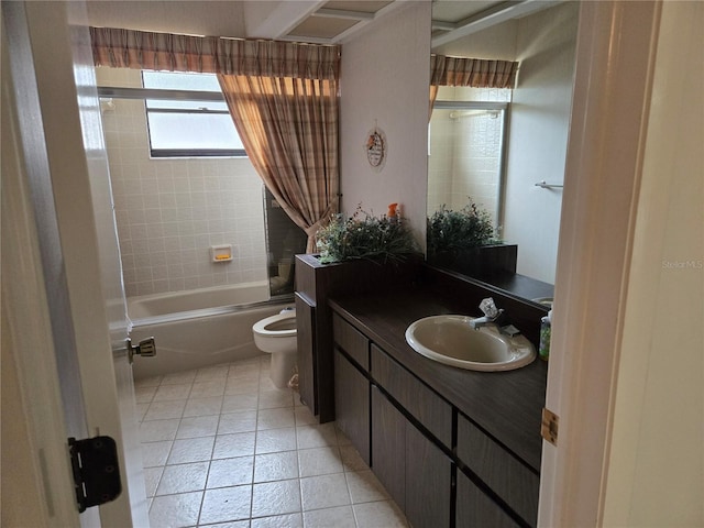 full bathroom featuring toilet, vanity, tile patterned floors, and tiled shower / bath combo