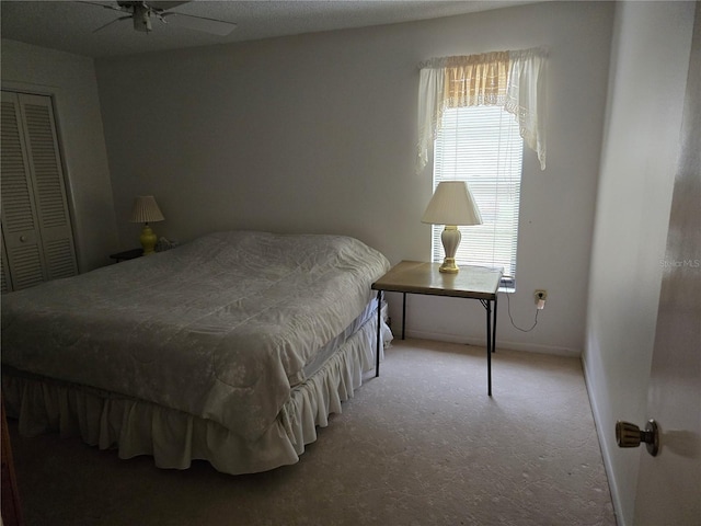 bedroom with a closet, ceiling fan, and carpet