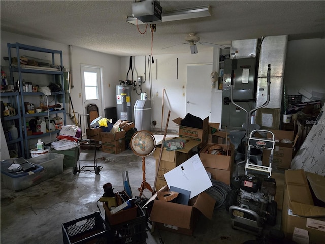 garage featuring water heater, a garage door opener, and ceiling fan