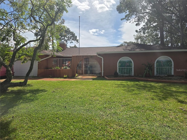 rear view of property with a yard