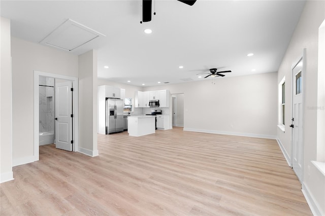 unfurnished living room with light wood-type flooring, a ceiling fan, and recessed lighting