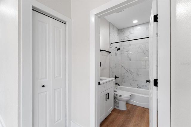 bathroom with toilet, a closet, wood finished floors, and vanity