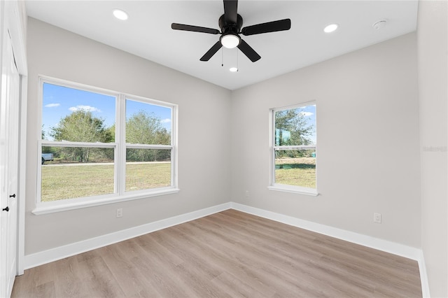 empty room featuring light wood-type flooring, ceiling fan, baseboards, and recessed lighting