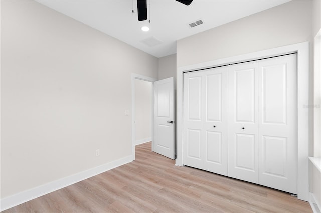 unfurnished bedroom featuring baseboards, visible vents, a ceiling fan, light wood-type flooring, and a closet