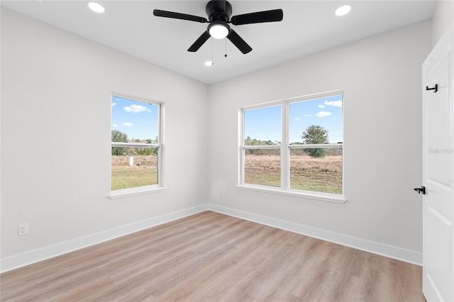 spare room with light wood-type flooring, ceiling fan, baseboards, and recessed lighting