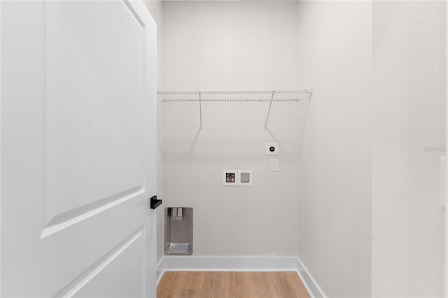 clothes washing area featuring laundry area, washer hookup, baseboards, light wood-type flooring, and electric dryer hookup