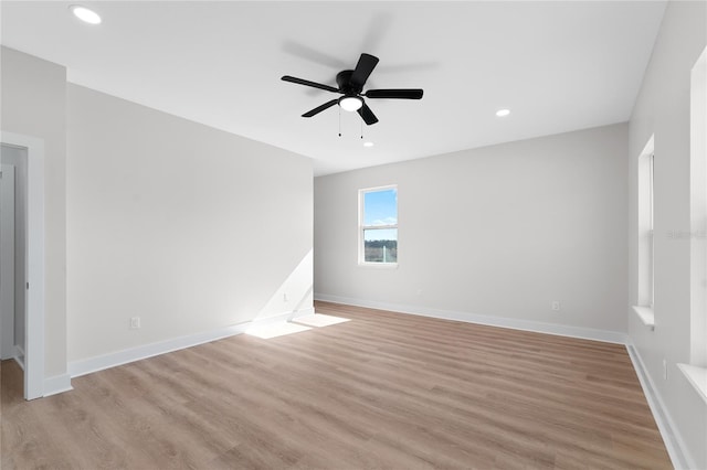 unfurnished room featuring ceiling fan, light wood finished floors, recessed lighting, and baseboards