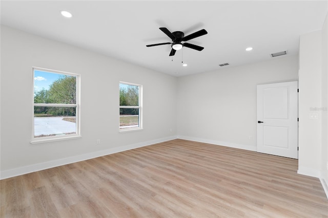 unfurnished room with light wood-style flooring, recessed lighting, visible vents, and baseboards