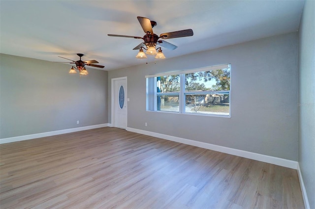 spare room featuring ceiling fan and light wood-type flooring