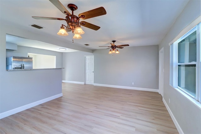 unfurnished room featuring ceiling fan and light hardwood / wood-style floors