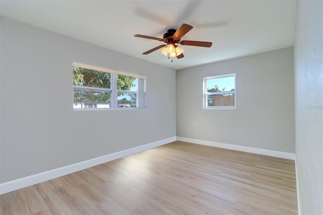 unfurnished room with ceiling fan, light wood-type flooring, and plenty of natural light