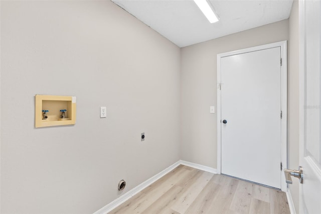 clothes washing area featuring light hardwood / wood-style floors, washer hookup, and hookup for an electric dryer