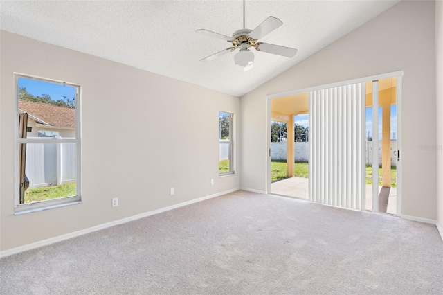 unfurnished room with light carpet, a textured ceiling, vaulted ceiling, and ceiling fan