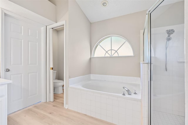 full bathroom featuring a textured ceiling, toilet, vanity, independent shower and bath, and hardwood / wood-style flooring