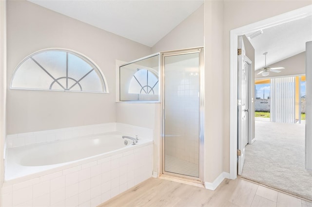 bathroom with hardwood / wood-style floors, independent shower and bath, lofted ceiling, and a wealth of natural light