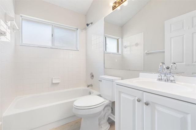 full bathroom with tiled shower / bath combo, toilet, and vanity