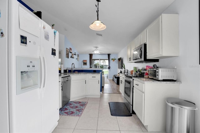 kitchen with stainless steel appliances, decorative light fixtures, white cabinetry, and kitchen peninsula