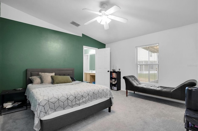 bedroom featuring lofted ceiling, ensuite bathroom, ceiling fan, and carpet