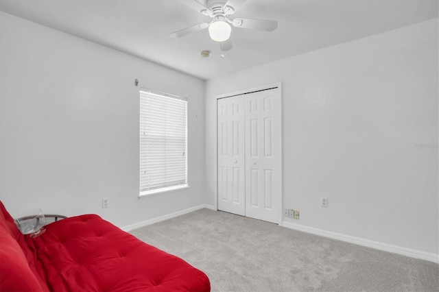 sitting room with ceiling fan and light carpet