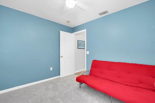 living area with ceiling fan and carpet flooring