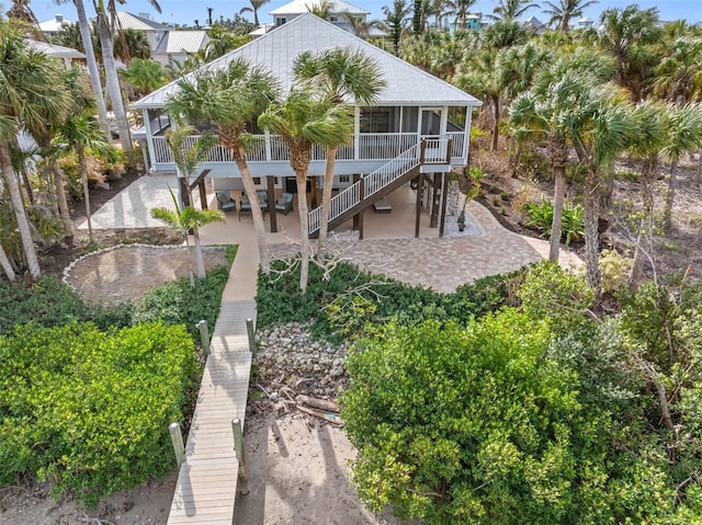 rear view of property with a patio area and a sunroom