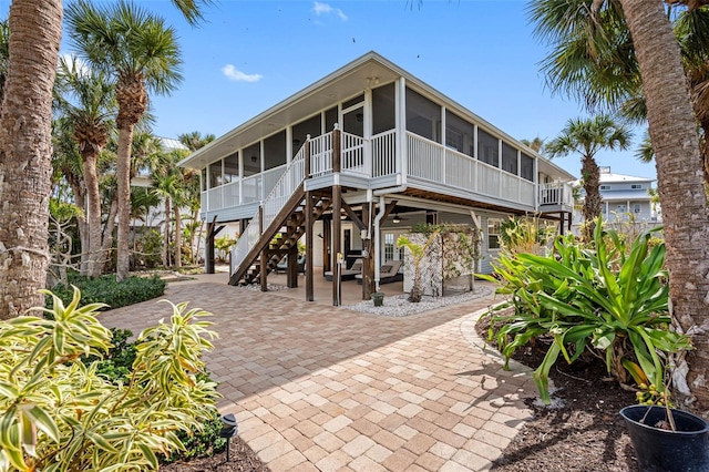 back of property with a sunroom