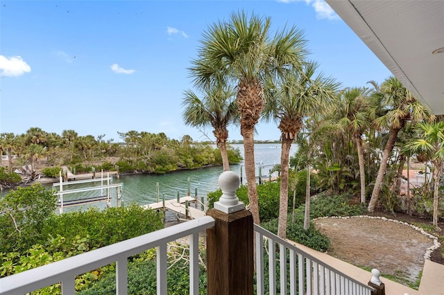 balcony featuring a water view and a dock