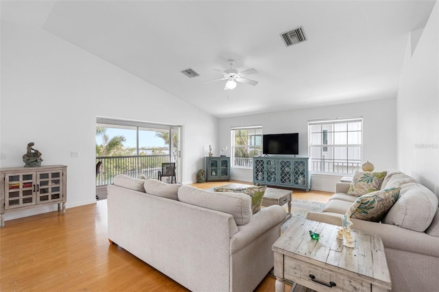 living room with ceiling fan, wood-type flooring, and lofted ceiling