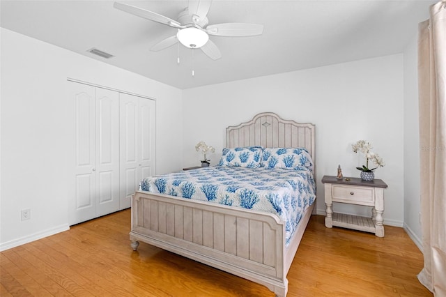 bedroom with hardwood / wood-style floors, a closet, and ceiling fan