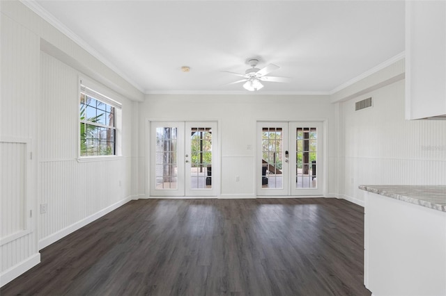 unfurnished living room featuring french doors, ceiling fan, crown molding, and dark wood-type flooring